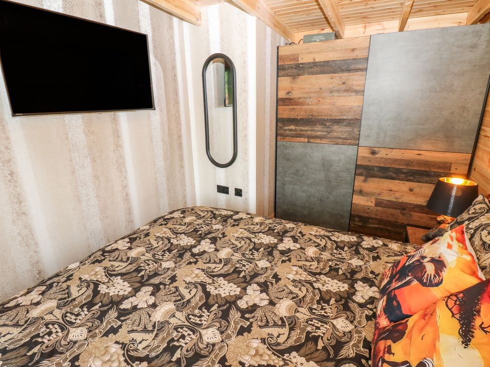 A bedroom with a bed and TV at Black River Houghton Bank near Heighington