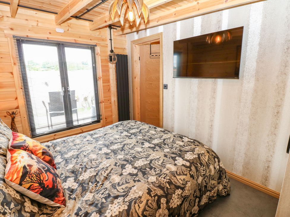 A bedroom with a bed and television at Black River in Houghton Bank near Heighington