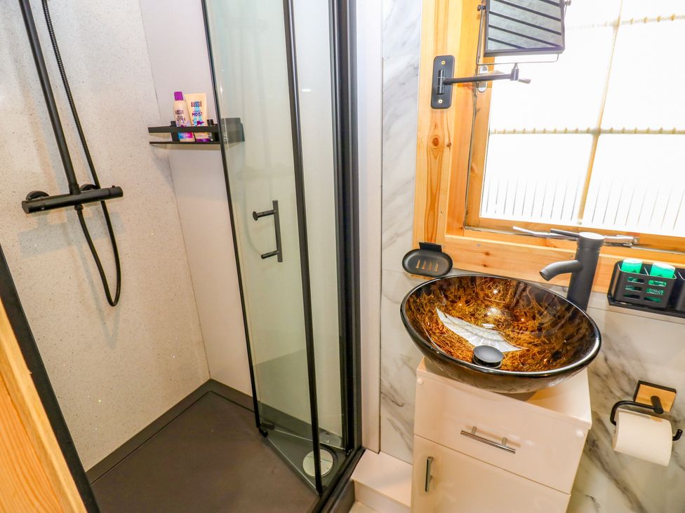 A bathroom featuring a shower, sink, and mirror at Black River in Houghton Bank near Heighington