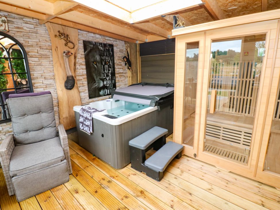 A hot tub and sauna in a relaxing indoor setting at Black River near Houghton Bank