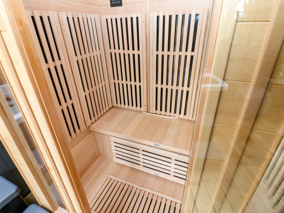 A sauna with wooden benches and wall panels at Black River near Houghton Bank