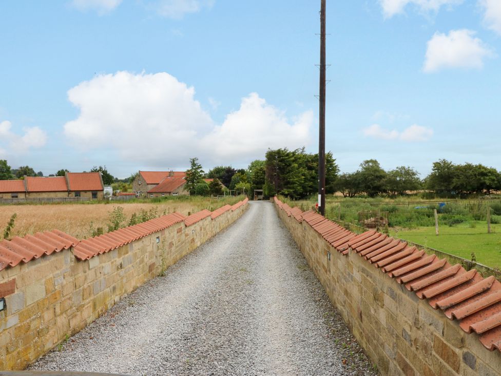 A gravel driveway leading to houses at Black River in Houghton Bank near Heighington