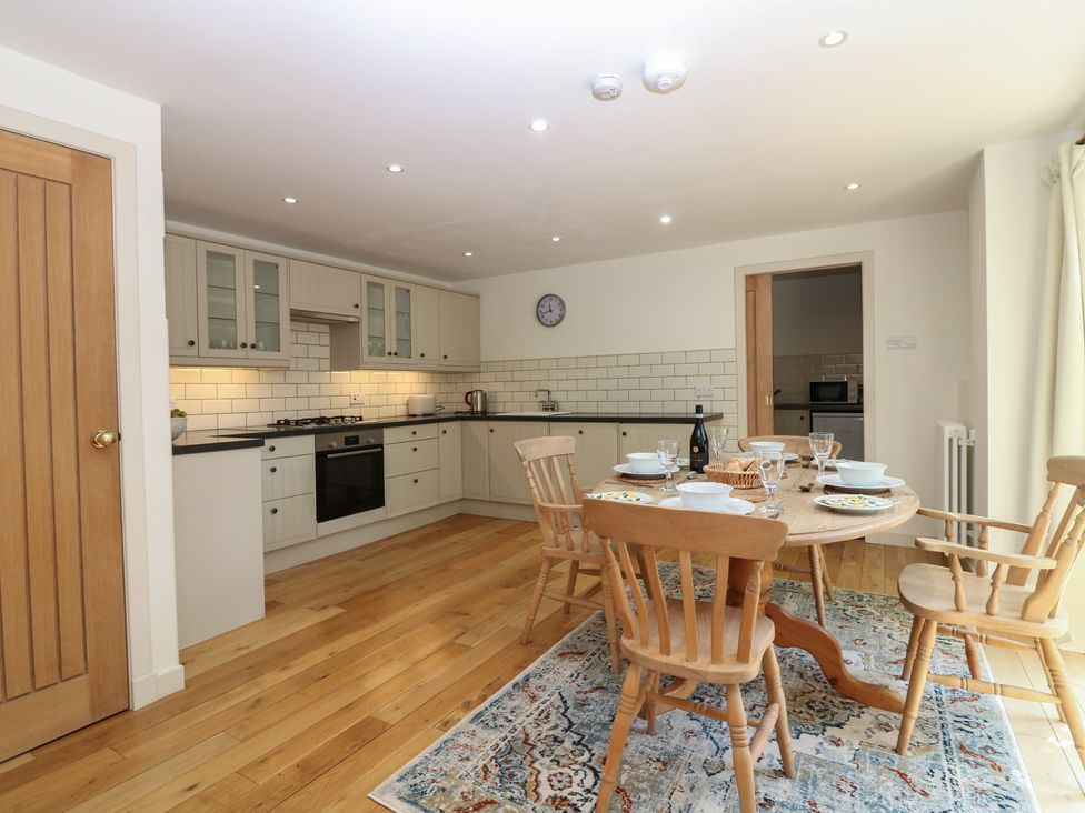 A kitchen with a dining table and chairs at Hollybank Barn near Melrose