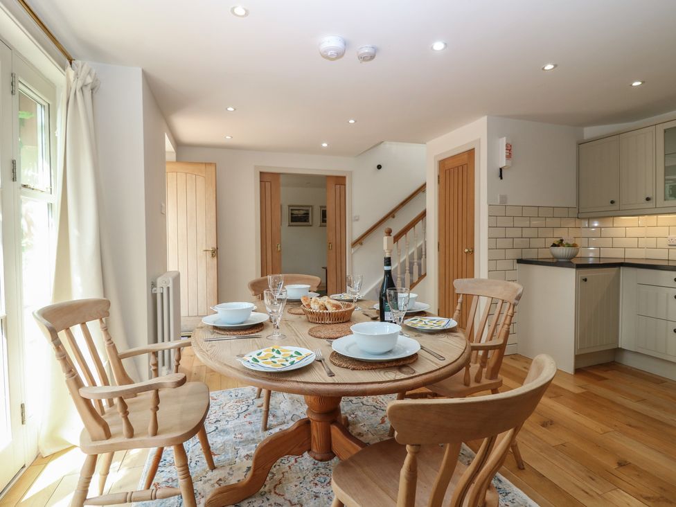 A dining room with a round table and chairs at Hollybank Barn near Melrose