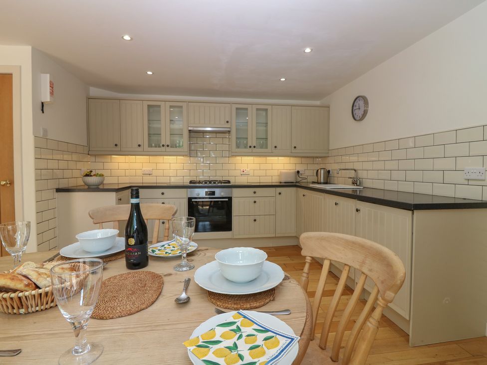 A kitchen with dining table and appliances at Hollybank Barn near Melrose