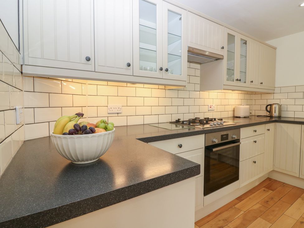 A kitchen with cabinets and a bowl of fruit at Hollybank Barn near Melrose