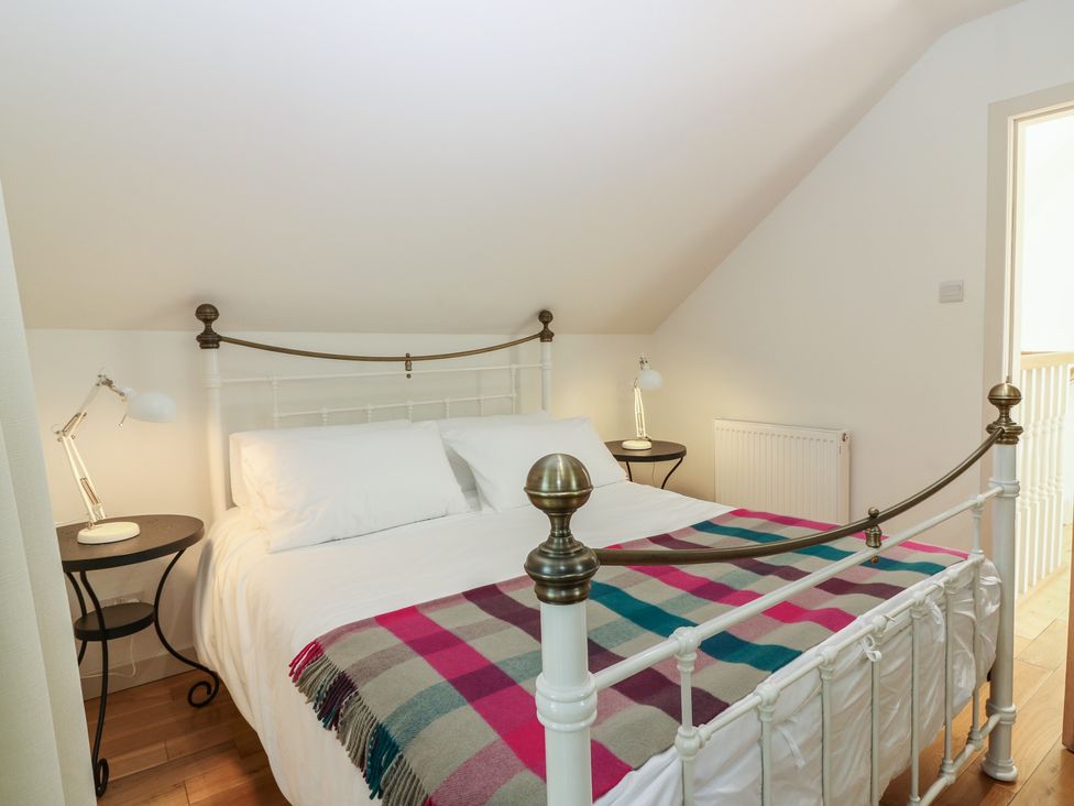 A bedroom with a bed and bedside tables at Hollybank Barn near Melrose