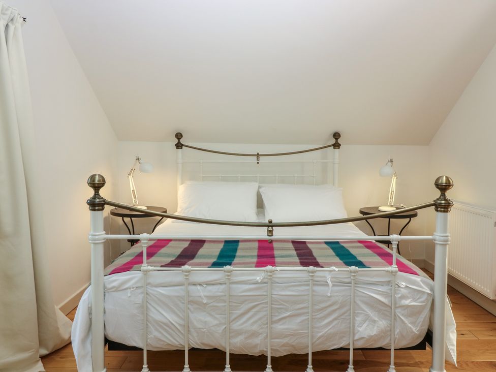 A bedroom with a bed and bedside tables at Hollybank Barn near Melrose