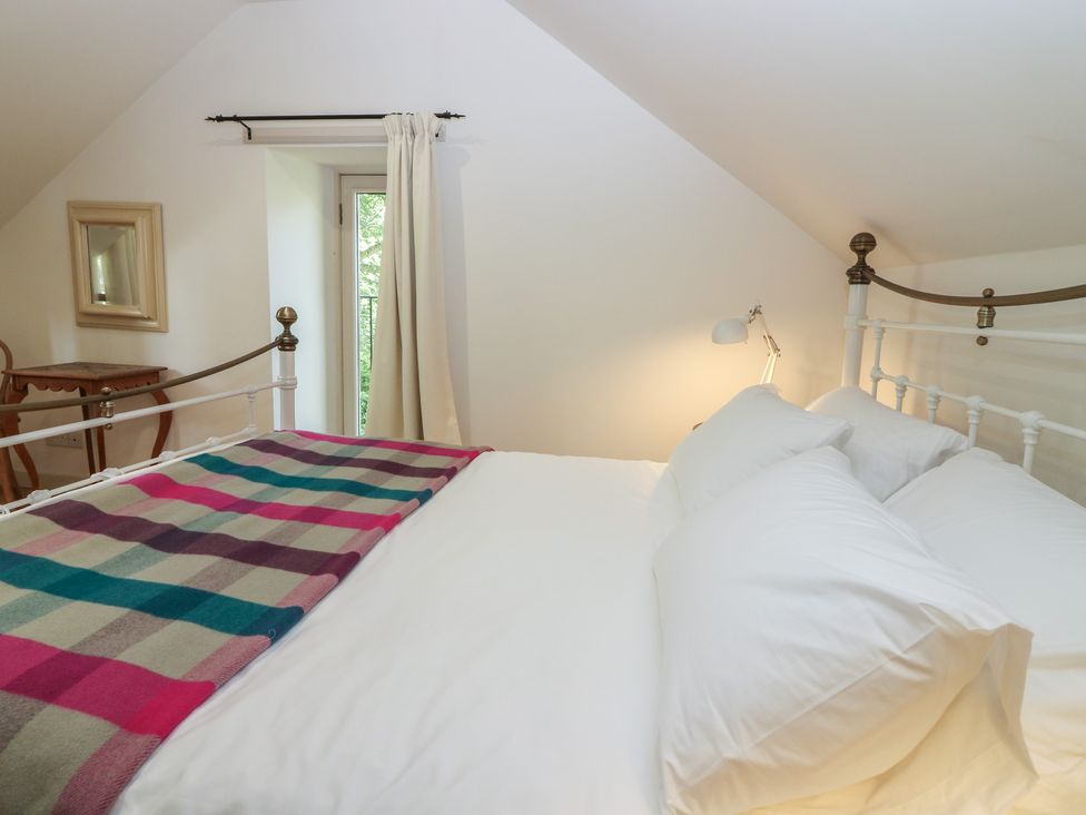 A bedroom with a bed and a table at Hollybank Barn near Melrose