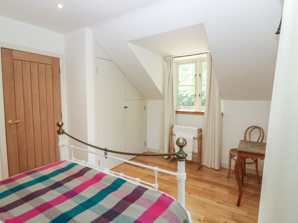 A bedroom with a bed and a small table at Hollybank Barn near Melrose