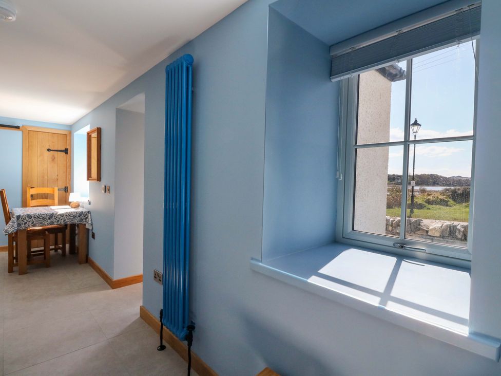 A dining room with a table and chairs at Post Cottage Arisaig