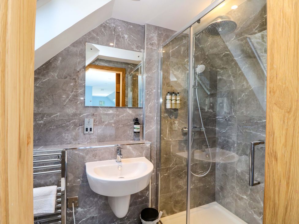 A bathroom with a sink and shower at Post Cottage in Arisaig