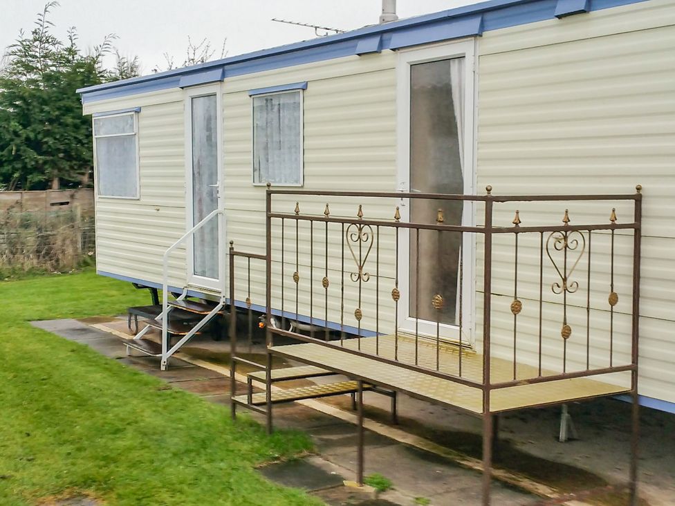 A caravan with steps and railing at Number 186 Owens caravan park Abergele