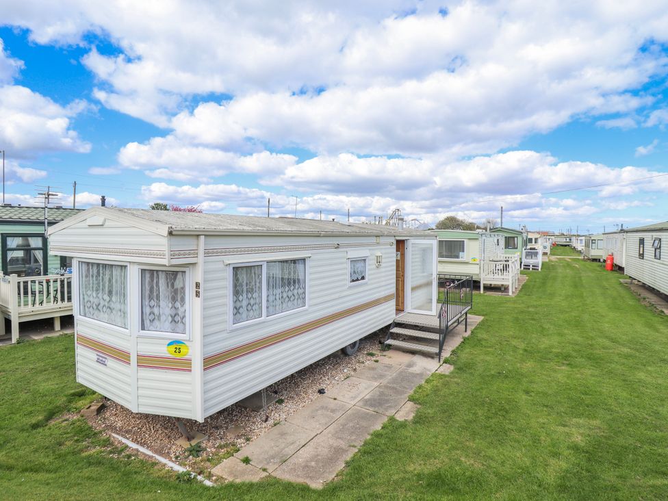 A caravan with steps and grass area at Caravan 25 in Skegness
