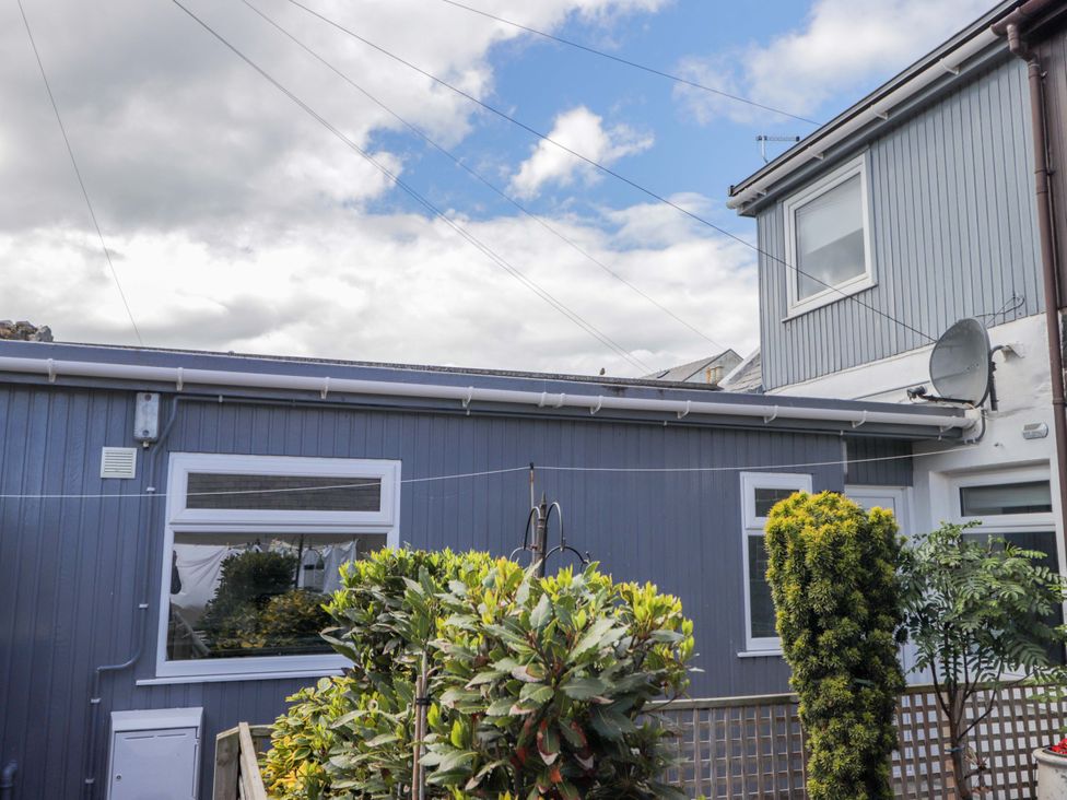 A house exterior with plants and a satellite dish at 4A Carny Street in Macduff