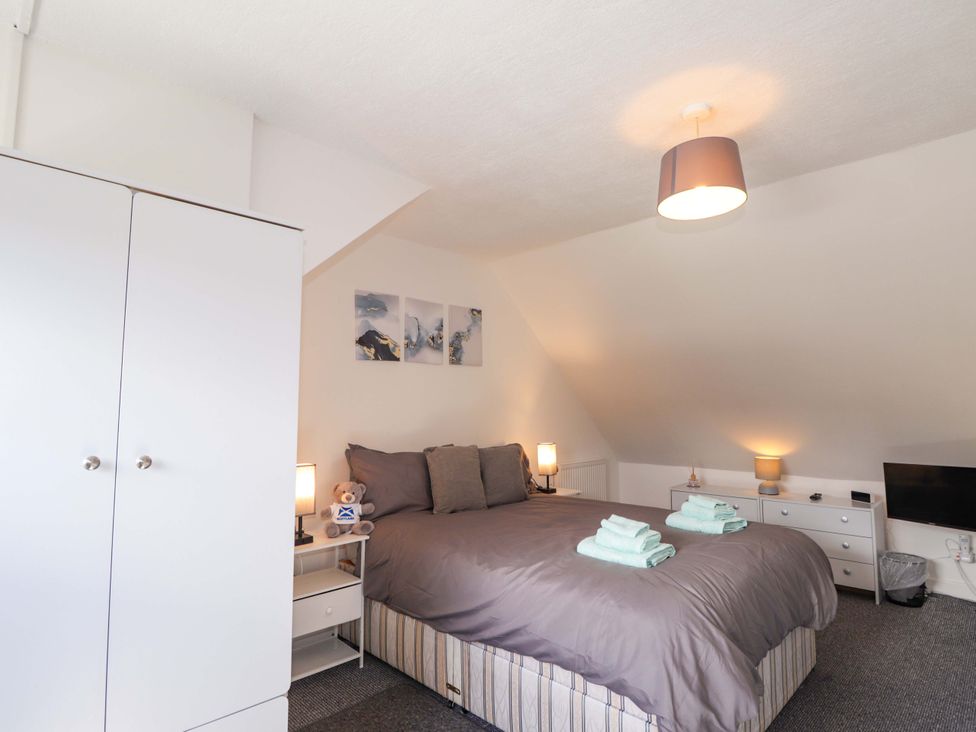 A bedroom with a bed and storage units at 4A Carny Street Macduff