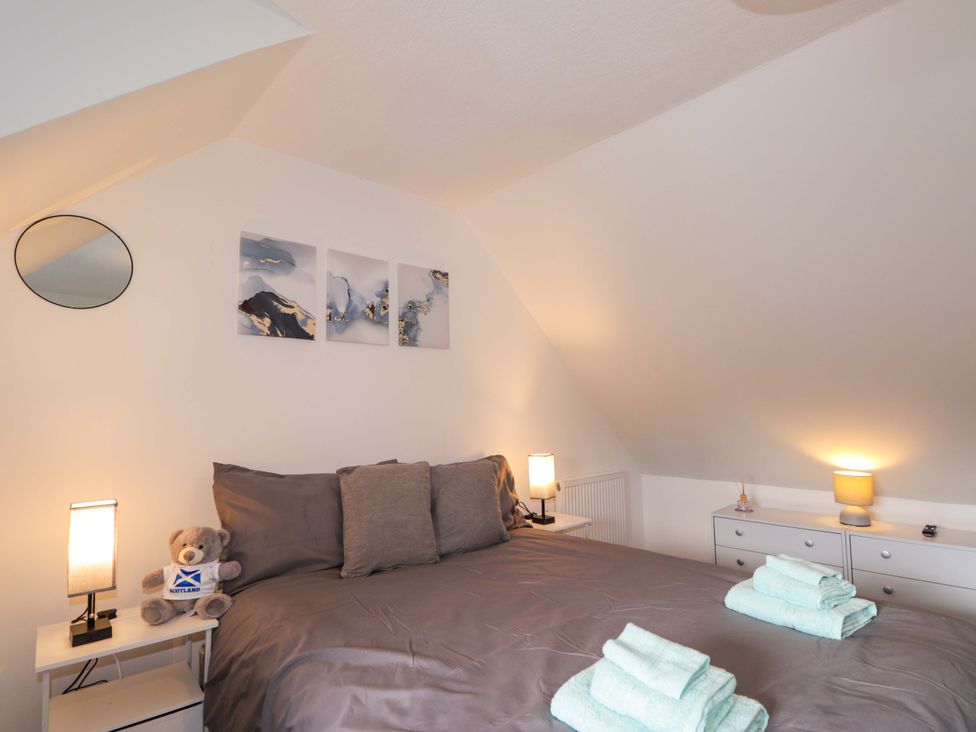 A bedroom with a bed and towels on it at 4A Carny Street Macduff