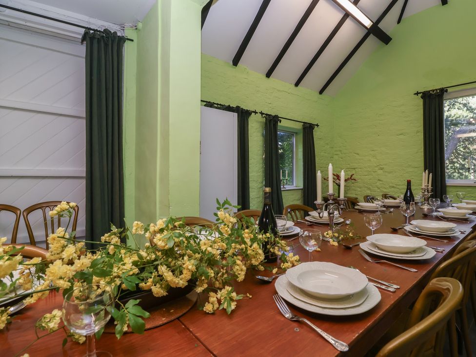 A dining room with a table set for a meal at The Old Stables in Gloucester