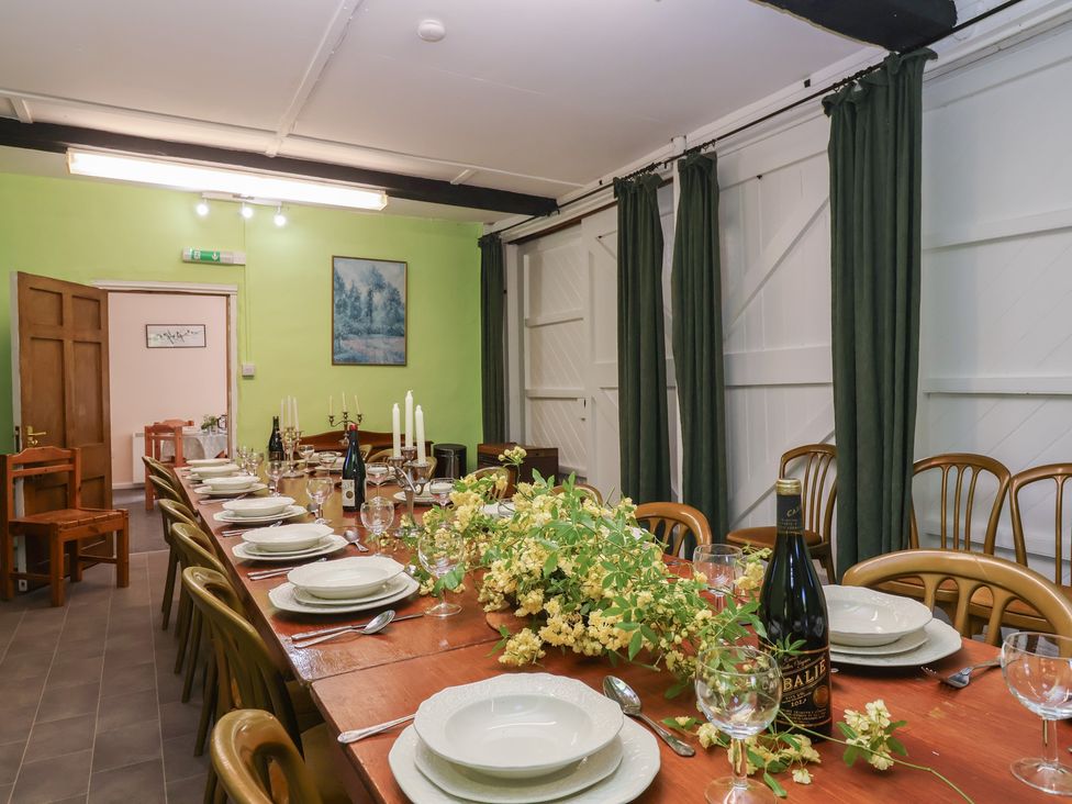 A dining room with a set table at The Old Stables in Gloucester