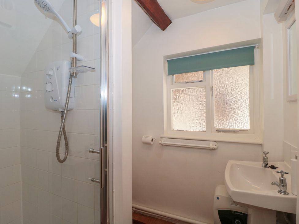 A bathroom with a shower and sink at The Old Stables in Gloucester