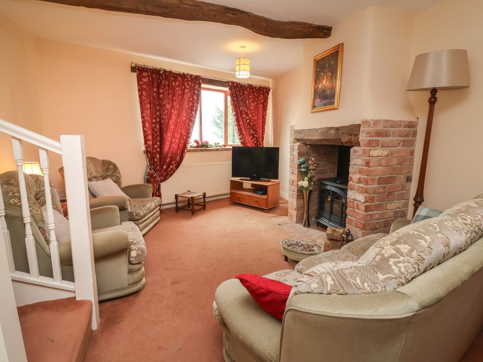 A living room with a television and fireplace at The Retreat near Wellington