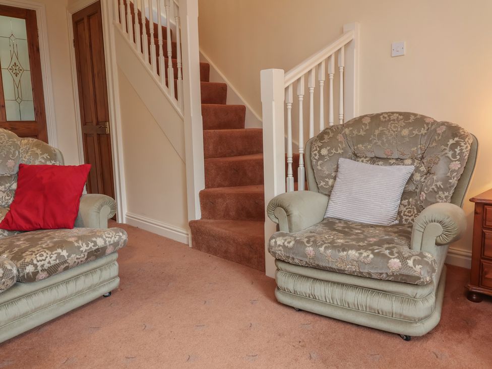 A living room with a sofa and armchair at The Retreat near Wellington