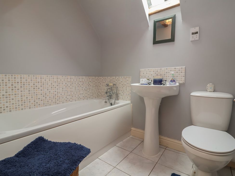 A bathroom with a bath tub, sink, and toilet at The Retreat near Wellington