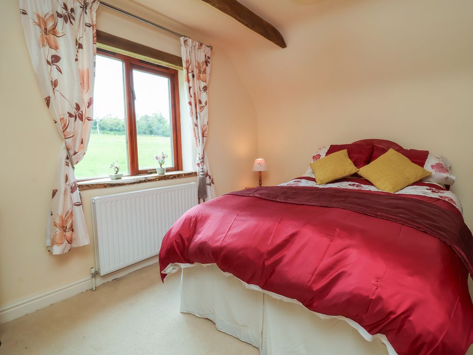 A bedroom with a bed and window at The Retreat near Wellington
