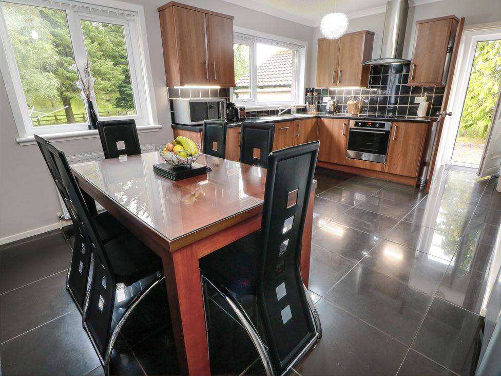 A kitchen with a dining table and chairs at Cliff View in Perth
