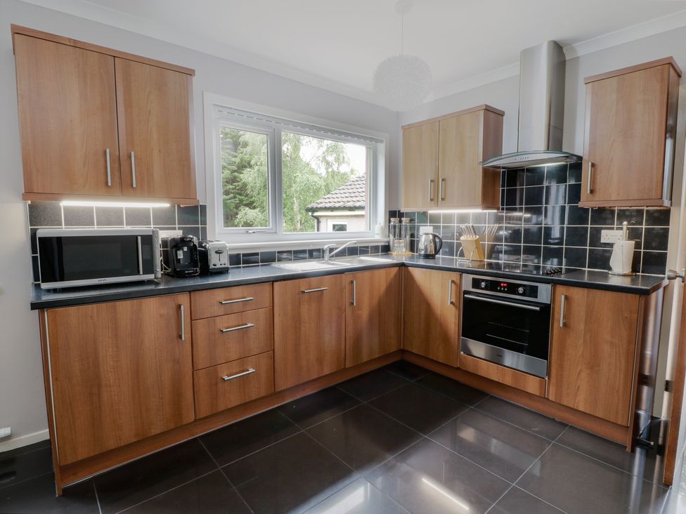 A kitchen with cabinets and appliances at Cliff View in Perth