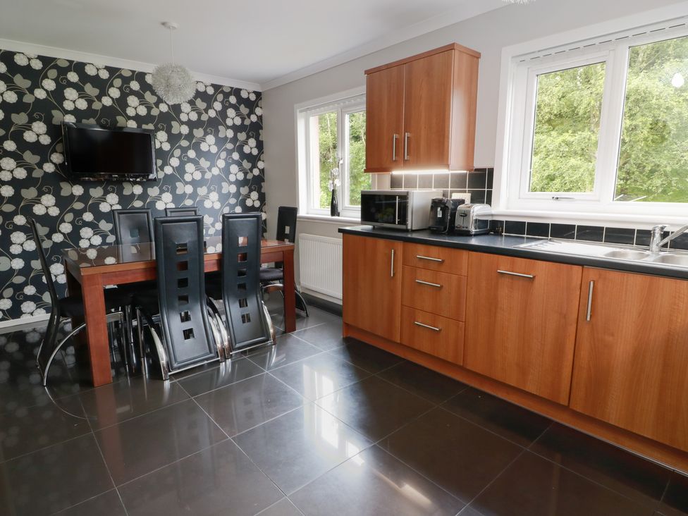 A kitchen with a table and chairs at Cliff View in Perth