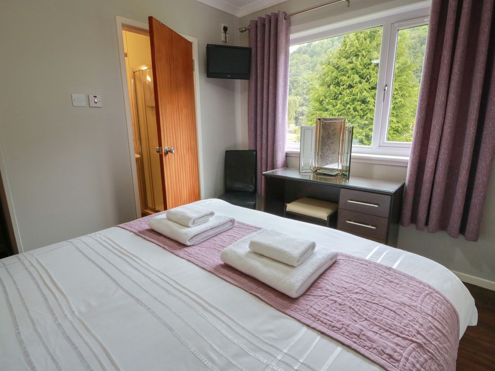 A bedroom with a bed and desk at Cliff View in Perth