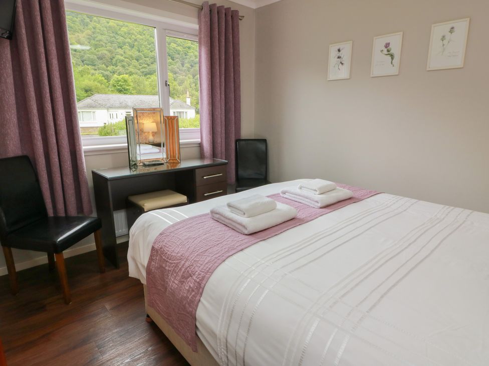 A bedroom with a bed and desk at Cliff View in Perth