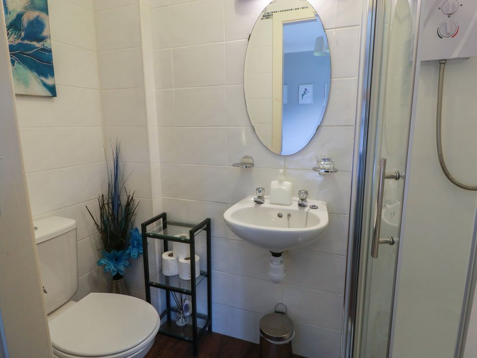 A bathroom with a shower, toilet, and sink at Cliff View in Perth