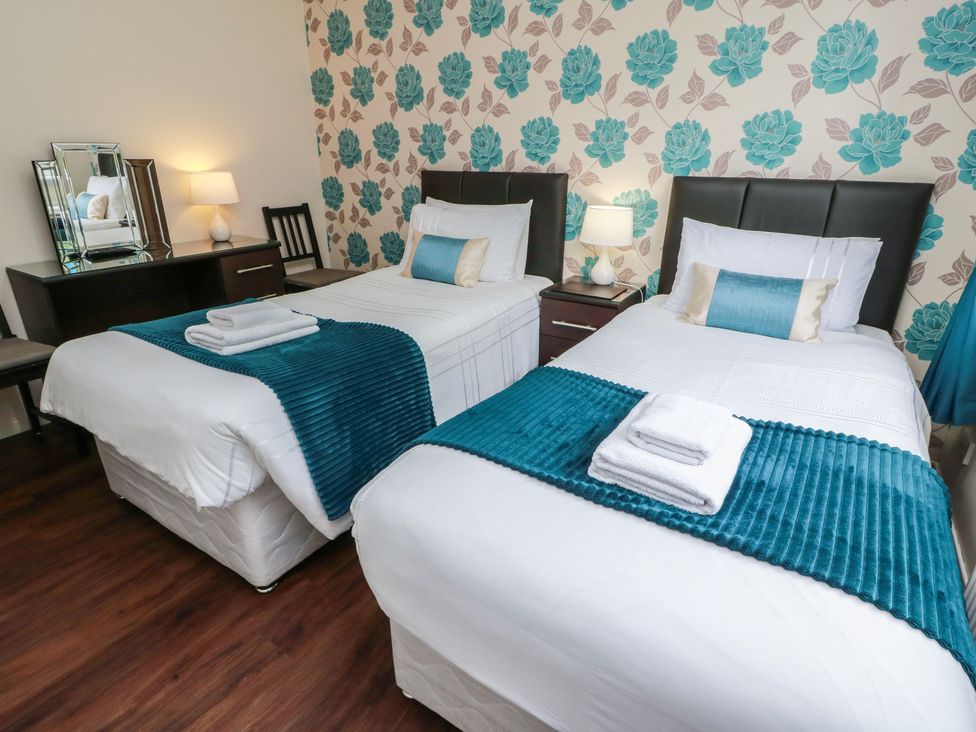 A bedroom with two single beds and a mirror at Cliff View in Perth