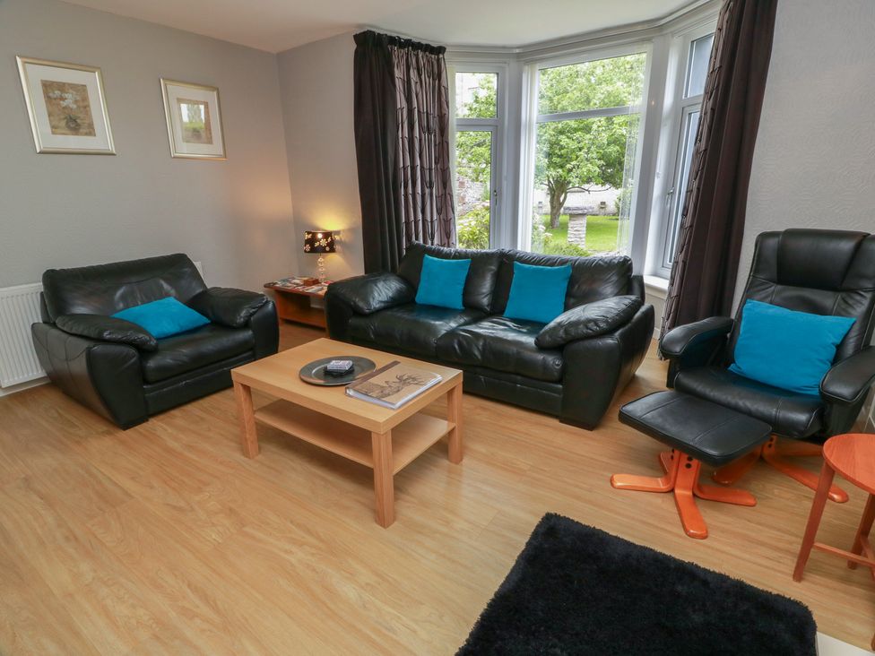 A living room with sofas and a coffee table at 1 St. Catherines Cottages in Perth