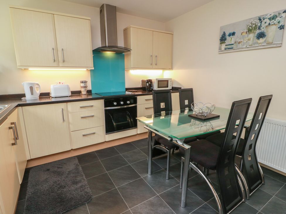 A kitchen with appliances and dining area at 1 St. Catherines Cottages in Perth