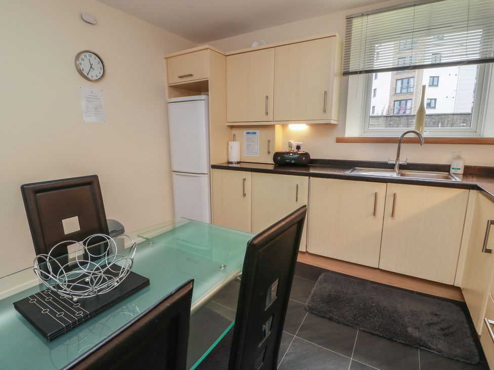 A kitchen with a table and chairs at 1 St. Catherines Cottages in Perth