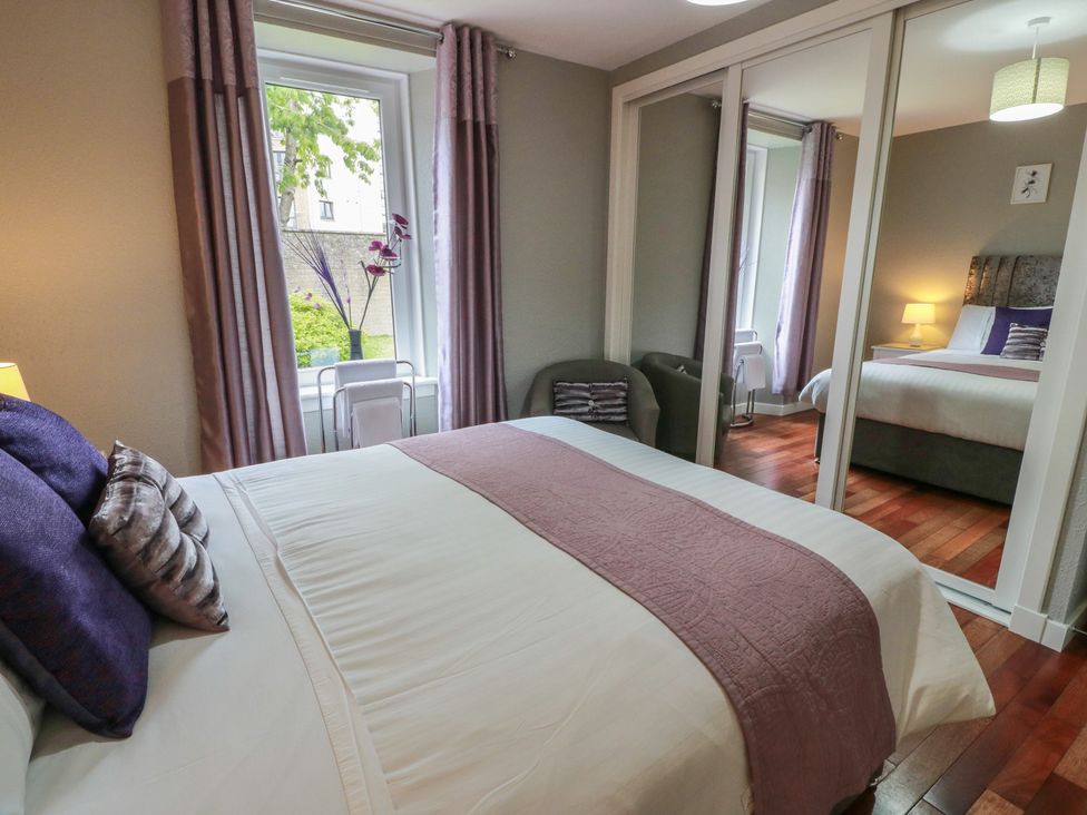 A bedroom with a bed and window at 1 St. Catherines Cottages, Perth