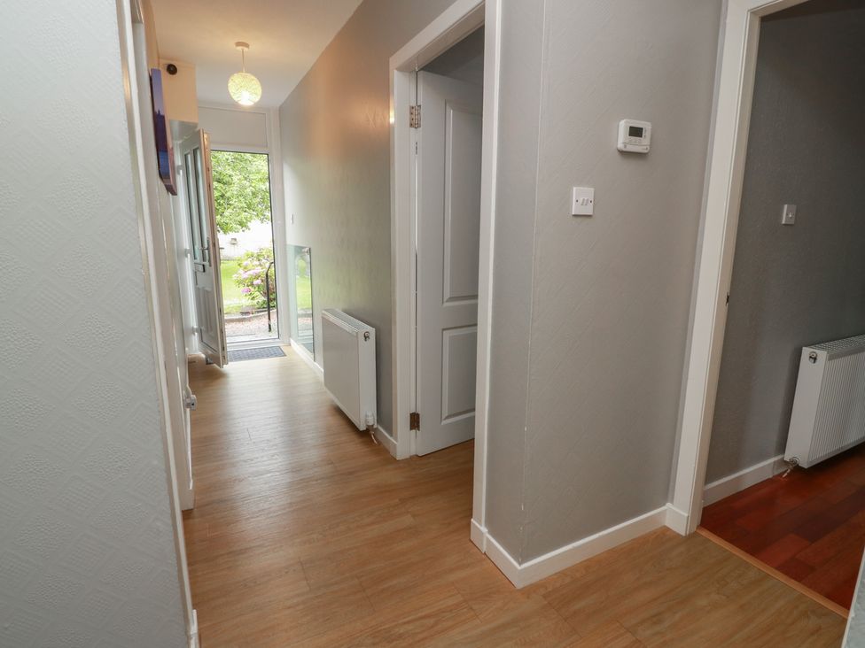 A hallway with a door and radiator at 1 St. Catherines Cottages in Perth