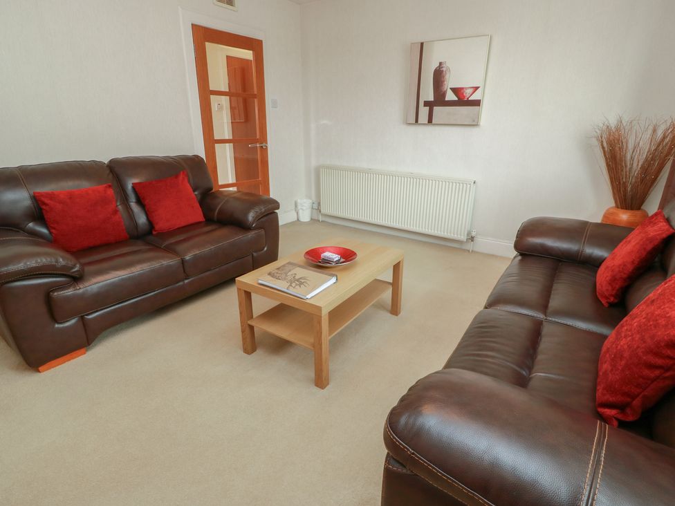 A living room with sofas and a coffee table at 2 St. Catherines Cottages, Perth