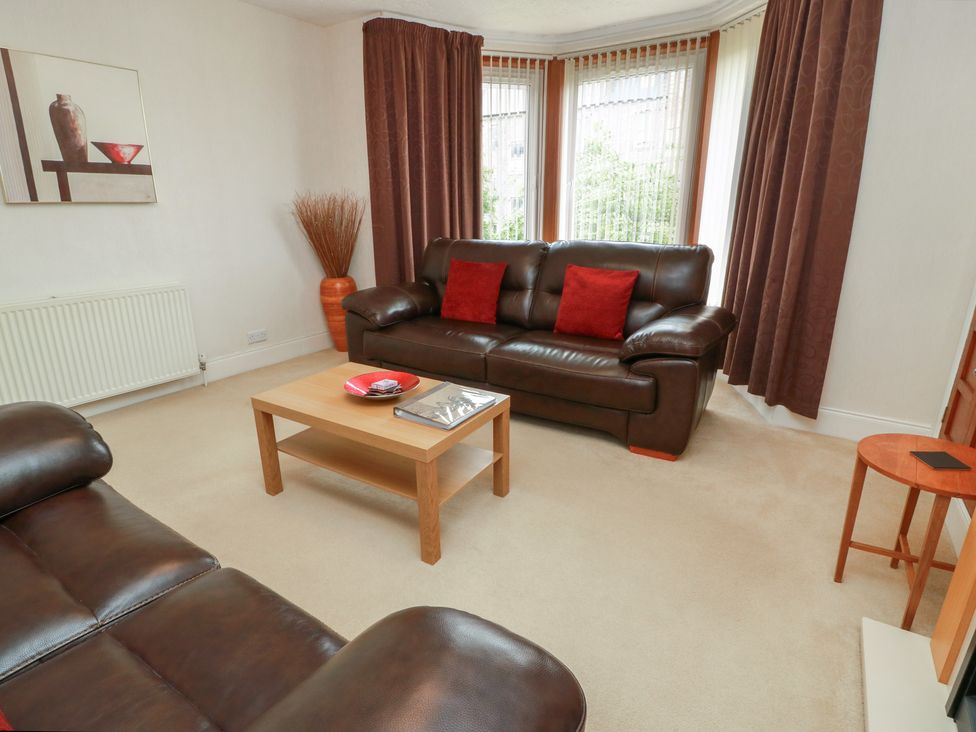 A living room with a sofa and coffee table at 2 St. Catherines Cottages in Perth