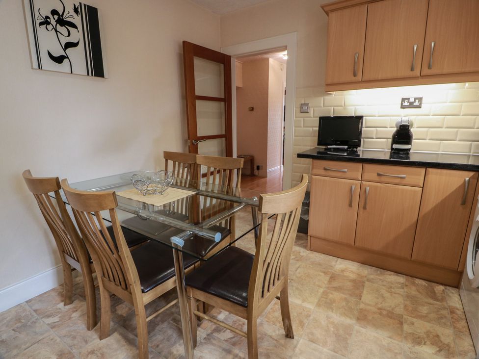 A kitchen with a dining table and chairs at 2 St. Catherines Cottages in Perth