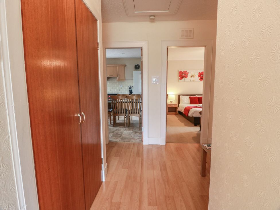 A hallway with access to a kitchen and sleeping area at 2 St. Catherines Cottages Perth