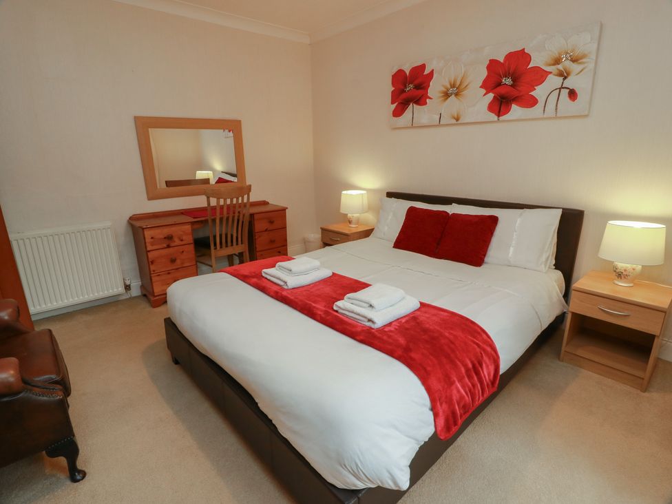 A bedroom with a double bed and desk at 2 St. Catherines Cottages in Perth