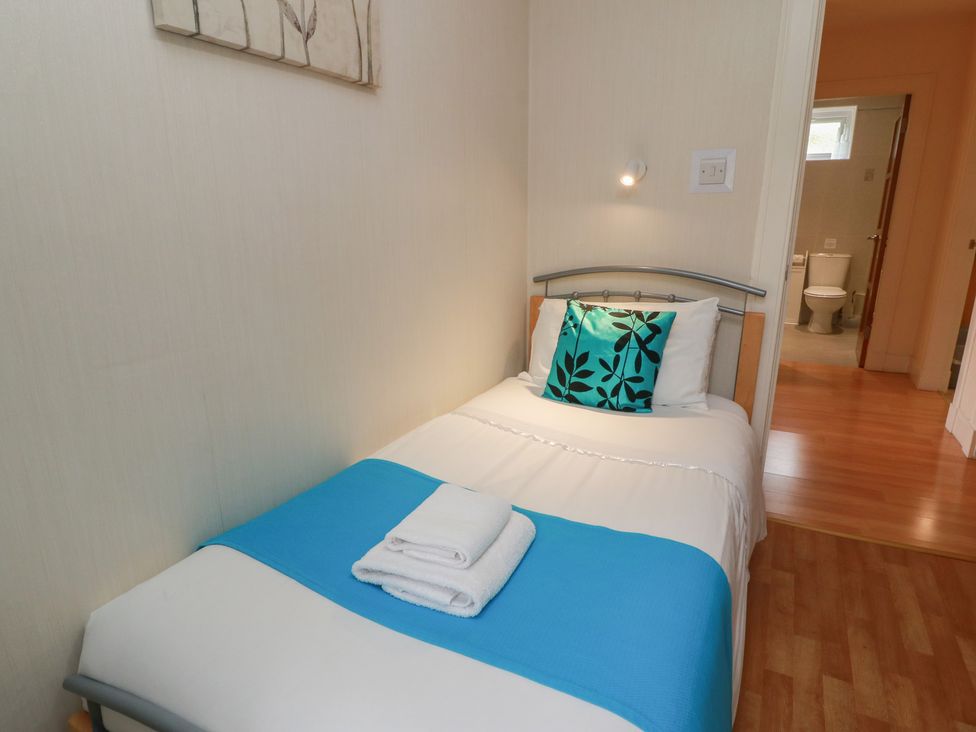 A bedroom with a bed and a bathroom visible at 2 St. Catherines Cottages Perth