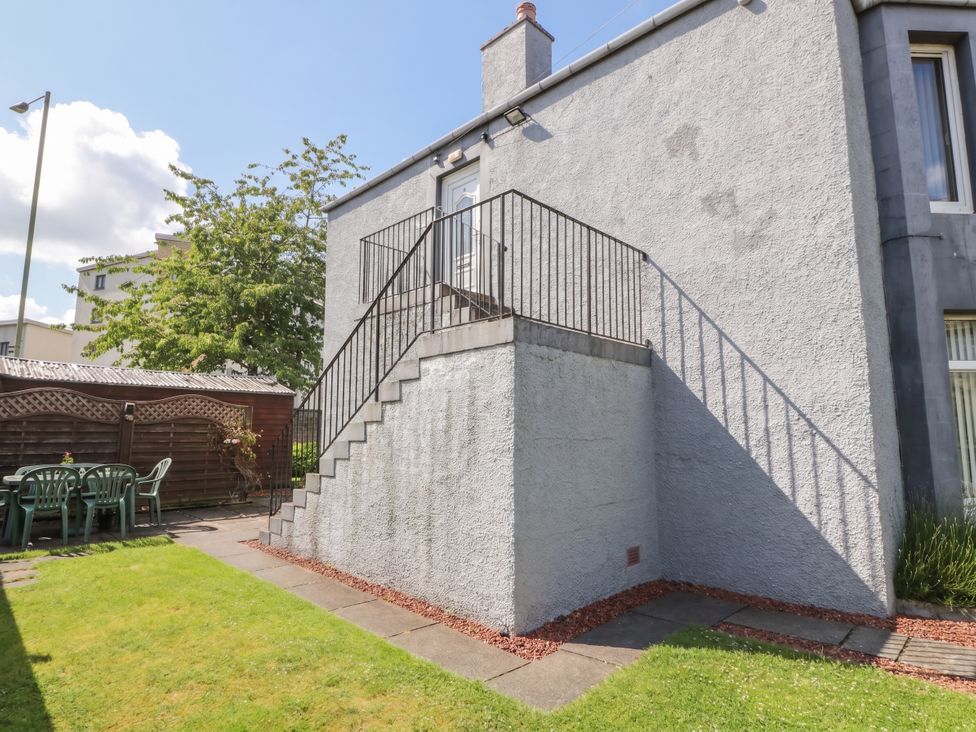 Stairs leading to a balcony with chairs in the garden at 2 St. Catherines Cottages in Perth