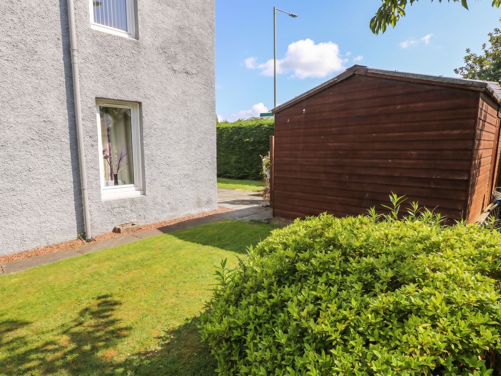 A garden area with a house, shed, and pathway at 2 St. Catherines Cottages in Perth