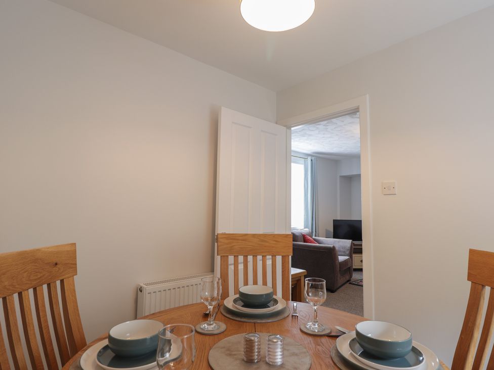 A dining room with a table set for four at 3 Bruaich Cottages near Strathpeffer