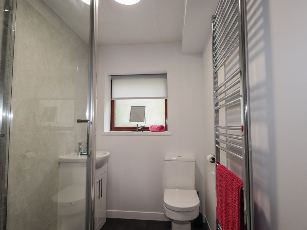 A bathroom with a shower, toilet, and sink at 3 Bruaich Cottages near Strathpeffer